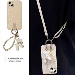 Camellia Flower and Puppy Pearl Charm Leather Crossbody Lanyard Phone Case for iPhone 16 Series