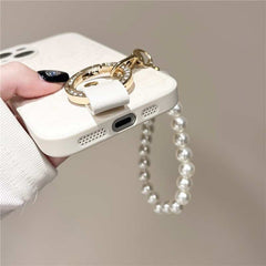 Camellia Flower and Puppy Pearl Charm Leather Crossbody Lanyard Phone Case for iPhone 14 Series